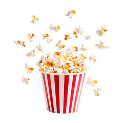 Popcorn in a red and white striped paper cup, flying isolated on a transparent background