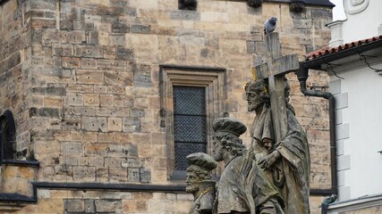statue of christian people with a big cross and pidgin on it 