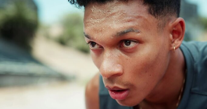 Face, tired man or athlete in stadium sweating of outdoor fitness training, cardio workout or sports exercise. Race track, rest or exhausted runner on break with fatigue or sweat in running practice