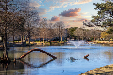Leonhardt Lagoon with lush green trees, plants and grass at Fair Park in Dallas in Dallas Texas USA