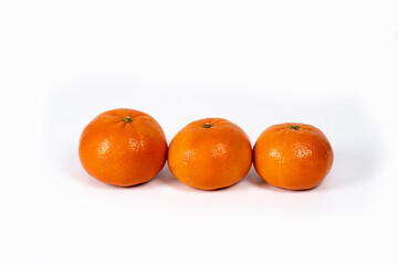 Fresh oranges lined up on a white surface showcasing vibrant color