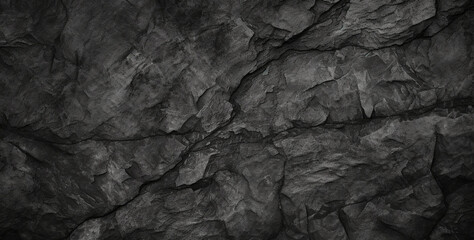 Naklejka premium Old stone wall. Dark stone texture. Black stone texture. Rock surface. Close-up. 