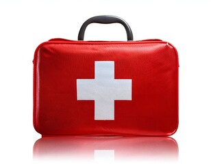 Obraz premium Red first aid kit with a white cross, perfect for medical or safety visuals. Compact and portable, suitable for travel, home, or outdoor use. Isolated on white background.