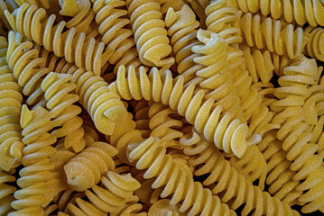 Dry uncooked Fusilli. It is a short, springy pasta that originated in Southern Italy. It has a spiral or corkscrew shape, and is often used in baked dishes, pasta salads, and with sauces.