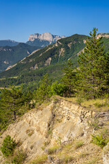 The famous “Trois Becs” Rochecourbe, le Signal and le Veyou, from Vercheny, Drôme, France.  Summer morning in the Drôme valley. Clairette de Die vineyard in the Drôme valley..
