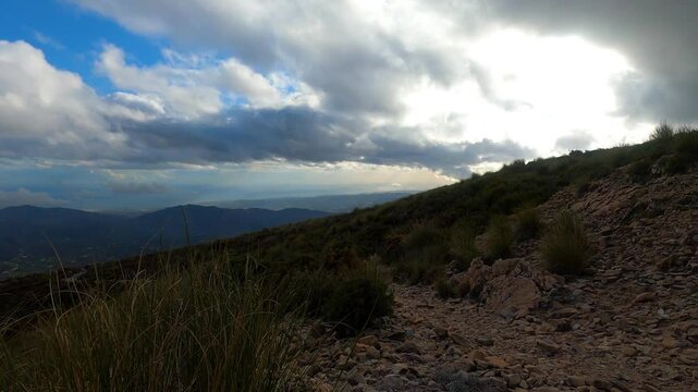 Fog and clouds on hiking trail to Maroma peak in thunderstorm day, Sierra Tejeda, Spain 