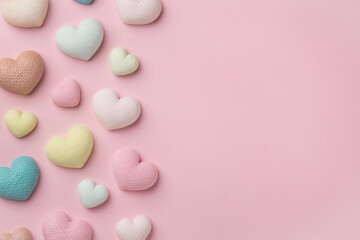 Colorful tiny hearts on pastel pink background. Minimal concept idea. Place for inscription. Top...