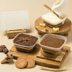 Delicious chocolate and creamy desserts pudding cake presented in clear containers on rustic wooden platters, garnished with chocolate shavings