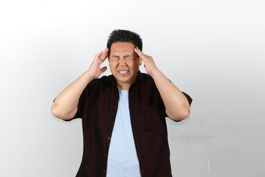 Man Suffering from very bad Headache, both hands on his head