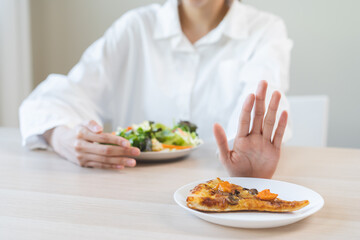 Diet concept, asian young woman close up hand push out away Pizza, refuse junk process, carb food...