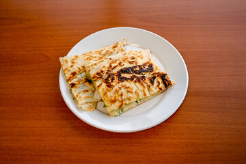 Turkish style meat stuffed filo dough borek served kol boregi. Cheese and minced pie are sliced on a marble background.  Avci boregi.Turkish name: Kol Boregi. Kiymali, peynirli su boregi.