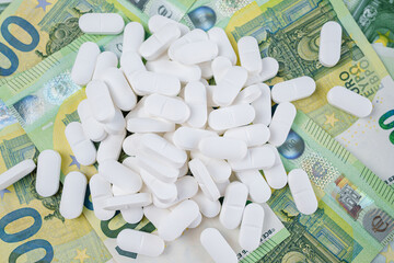 Pile of White Pills Resting Upon Euro Currency Notes Symbolizing Healthcare Costs