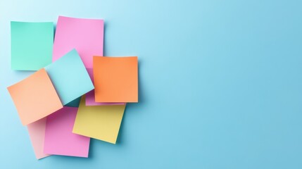 Colorful Sticky Notes Stacked on a Soft Blue Surface for Creative Workspace Organization and Communication