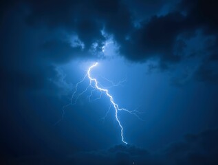 Lightning bolt illuminating dark swirling clouds during dramatic thunderstorm