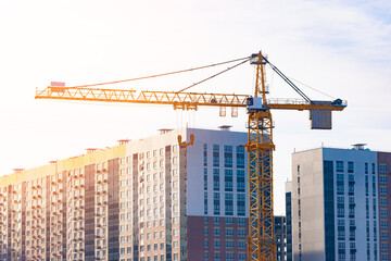construction crane against the background of constructed residential buildings. new residential area
