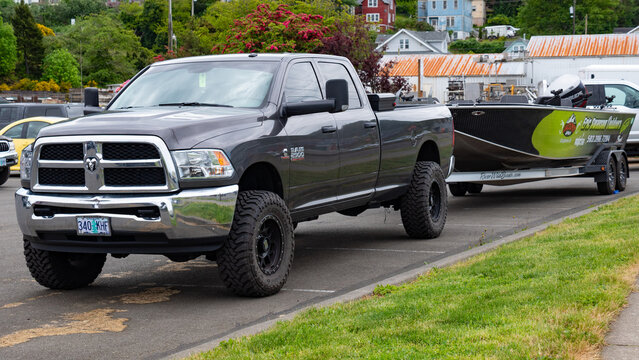 Astoria, Oregon, USA - May 21, 2019: 2014 Dodge RAM 2500 car. Dodge RAM pickup truck with boat. Pickup truck of Dodge RAM outdoor. Dodge RAM, corner view