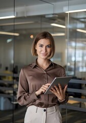 Happy professional female company executive, smiling Hispanic business woman entrepreneur, businesswoman corporate leader manager standing in office looking at camera using tablet. Portrait.