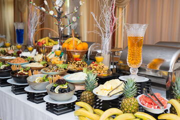 Snacks for the holiday, catering. Various snacks. Assortment of salads and buffet dishes. Meat, fish, cheese, salads, fruits and vegetables, sauces and canapes for celebrating a festive event.
