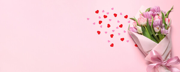 Bouquet of beautiful tulip flowers and paper hearts on pink table, top view. Banner design with space for text