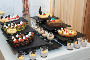 Party reception. Dessert buffet. A table filled with assortment of deserts. Catering for an event.