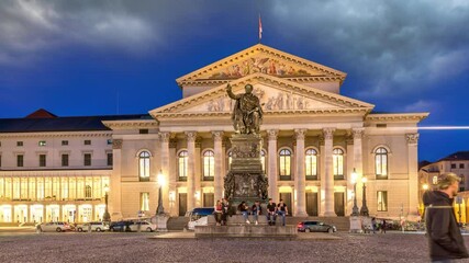 Munich National Theatre or Nationaltheater on the Max Joseph square night time lapse hyperlapse. Historic opera house, home of the Bavarian State Opera. The statue in the center. Germany
