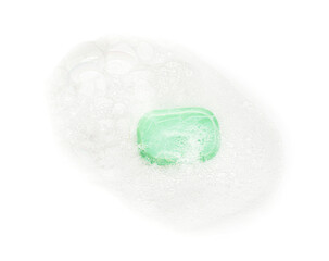 Green soap with foam on white background, top view