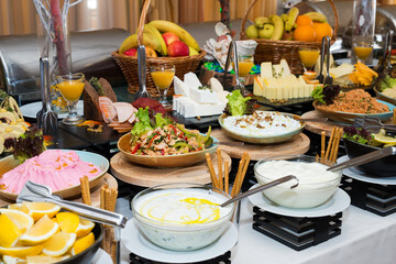 Snacks for the holiday, catering. Various snacks. Assortment of salads and buffet dishes. Meat, fish, cheese, salads, fruits and vegetables, sauces and canapes for celebrating a festive event.