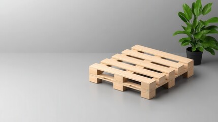 Empty wooden pallet on grey surface with green potted plant in modern interior setting for versatile background use