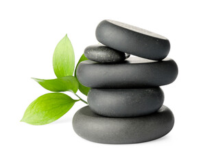 Stacked spa stones and green leaves isolated on white
