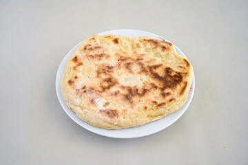 Freshly baked appetizing Turkish tortillas - Gozleme with spinach, cheese  on a white board. Space for text. Handmade Turkish traditional pastries. Ispanakli, otlu peynirli gozleme. Tahinli Katmer