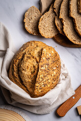 Whole Artisanal Sourdough Bread Loaf with Seeds, crunchy golden crust- flat lay