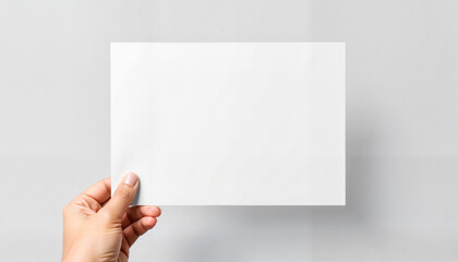 Fototapeta premium Hand holding blank paper against white background