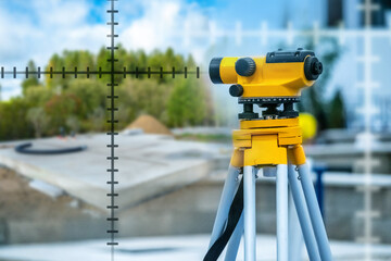 Geodetic equipment. Optical geodetic instrument on tripod. Surveyor instrument on construction site...