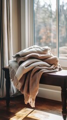 Cozy Neutral Throw Blankets Textured on Wooden Bench in Sunlight