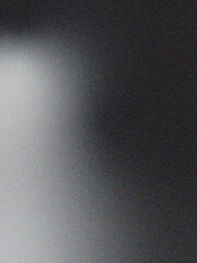 White and black abstract background with a dark, grainy noise texture, ideal for mobile header covers, wallpapers, and backdrop designs.