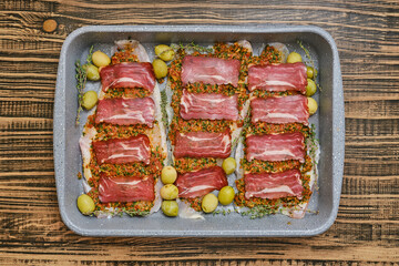 Deliciously prepared meat dish arranged on a rustic wooden surface prior to baking