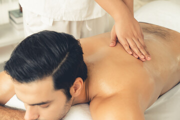 Caucasian man customer enjoying relaxing anti-stress spa massage and pampering with beauty skin...