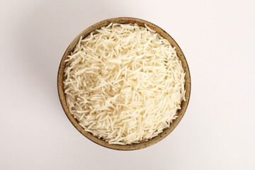 Plain Cooked White Rice in ceramic brown bowl on orange background.