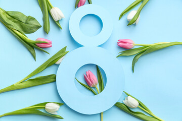 Obraz premium Figure 8 made of paper and beautiful tulips on blue background. International Women's Day