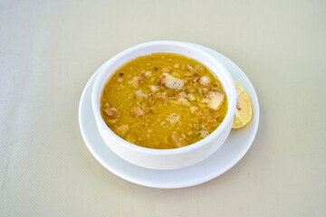 Homemade turkish soup Tavuk Suyu corbasi in a white ceramic soup plate.Turkish noodle chicken broth soup on a plate. Turkish meal (sehriyeli tavuk suyu corbasi). Ezo Gelin Corbasi. Islkembe, corbasi