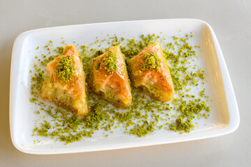 Turkish Dessert Sobiyet, havuc dilimi, midye baklava, mussels baklava and classic baklava with Pistachio . Cikoltali cevizli, fistikli soguk Baklava, top view.