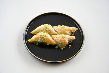 Turkish Dessert Sobiyet, havuc dilimi, midye baklava, mussels baklava and classic baklava with Pistachio . Cikoltali cevizli, fistikli soguk Baklava, top view.