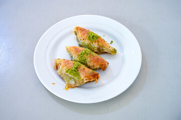 Turkish Dessert Sobiyet, havuc dilimi, midye baklava, mussels baklava and classic baklava with Pistachio . Cikoltali cevizli, fistikli soguk Baklava, top view.