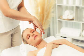 Caucasian woman enjoying relaxing anti-stress head massage and pampering facial beauty skin...