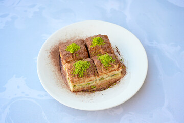 Turkish Dessert Sobiyet, havuc dilimi, midye baklava, mussels baklava and classic baklava with Pistachio . Cikoltali cevizli, fistikli soguk Baklava, top view.