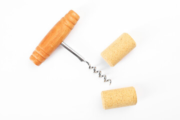 Corkscrew and corks on white background, top view