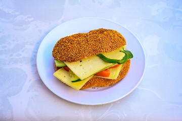 Close-up shot of Izmir's famous Turkish Traditional Kumru Sandwich, Ceşme Kumru, patso ingredients ready to eat salami, soudjouk, tomato, cheddar cheese and fried cheese. Yengen sandvic. Izmir karisik