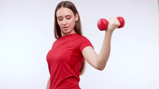 Young beautiful girl in a red T-shirt shows wet armpits after doing sports. Treatment of hyperhidrosis.