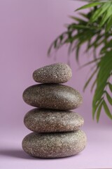 Stack of rocks on lilac background. Harmony and life balance