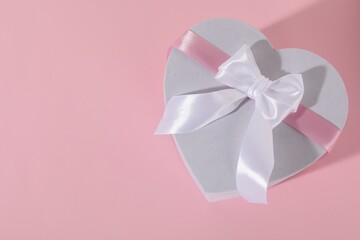 Beautiful wedding gift on pink background, top view. Space for text